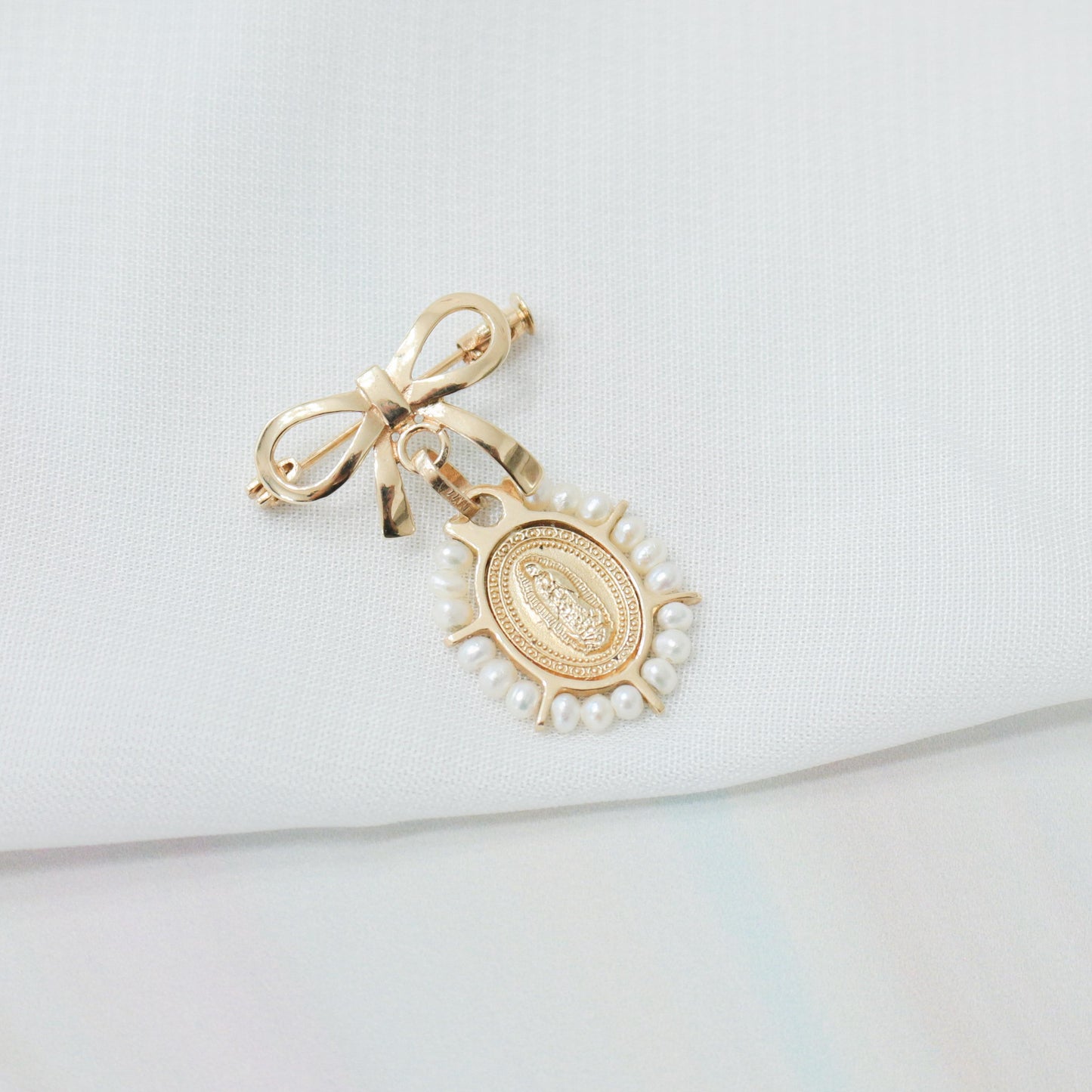 Medalla de perlitas con broche de moñito